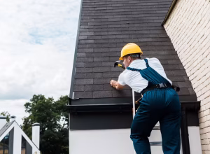 repairman-in-uniform-and-helmet-repairing-roof-whi-2024-11-18-10-44-36-utc (1)